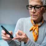 woman conducting diabetes blood prick test