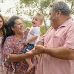 aboriginal family standing and laughing together