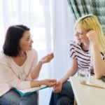 Doctor talking to young woman