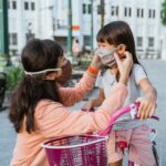 Mother putting mask on young child