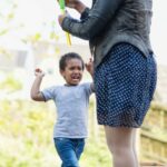 a young boy throws tantrum at his mother